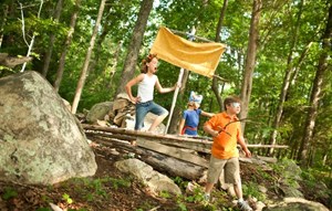 Kids playing with tree ship in forest