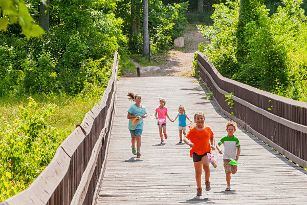 kids running along boardwalk trail in Briar Chapel