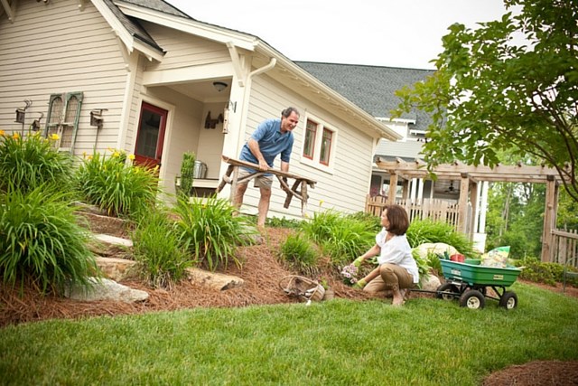 Couple gardening in backyard of home in Briar Chapel.