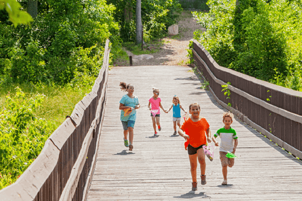 Kids running along boardwalk trail