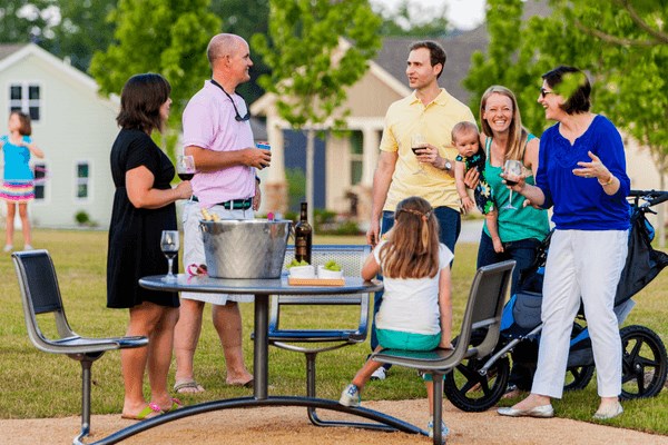 Families enjoying outside picnic at park