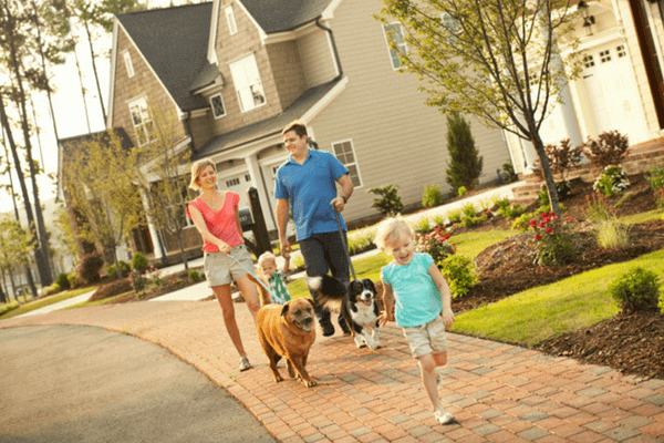 couple walking their dog through Briar Chapel