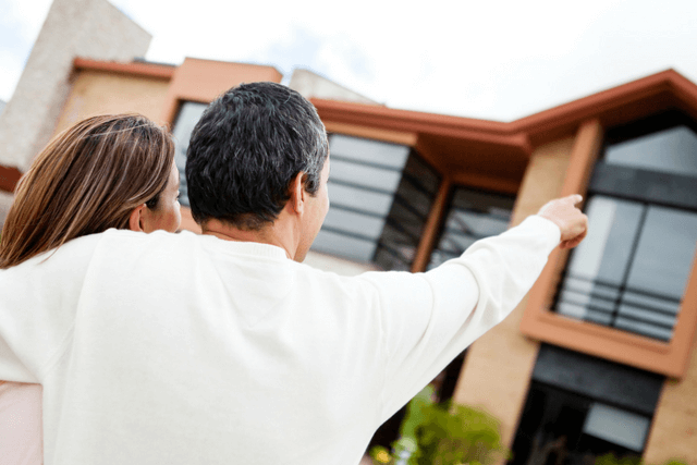 Couple looking at outside of home