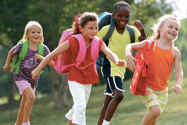 school kids running with backpacks