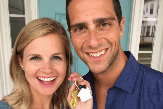 Young couple holding keys to new home in Briar Chapel.