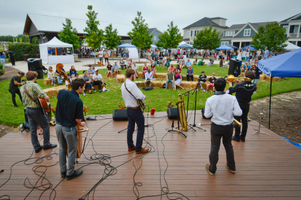 band playing on stage at outdoor fesitval