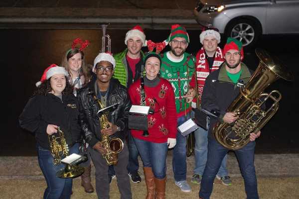 group of young professionals caroling