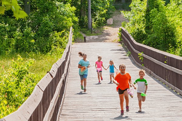 kids running along boardwalk trail in Briar Chapel.