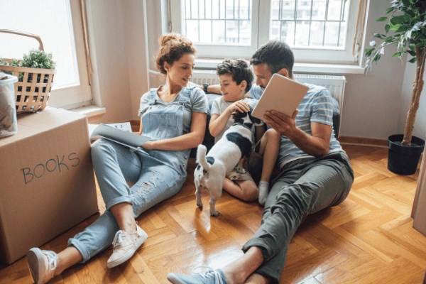 Family and dog reading together.