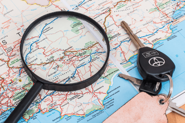 Car keys and magnifier on a road map