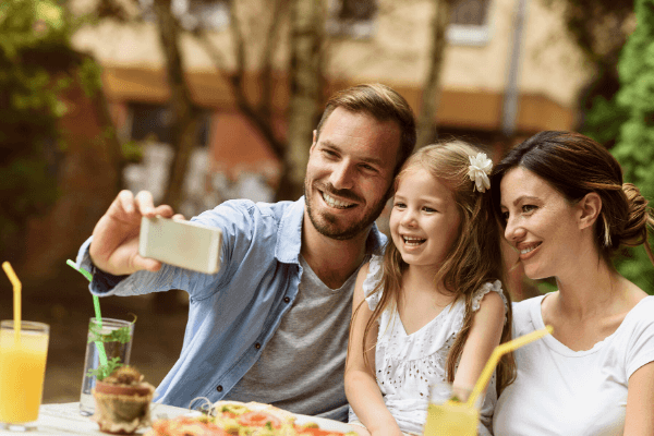 family filming video with phone