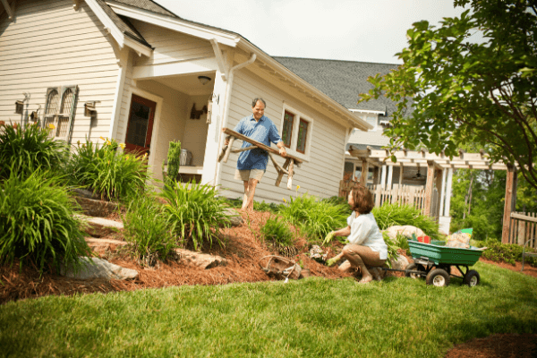 couple creating garden in backyard