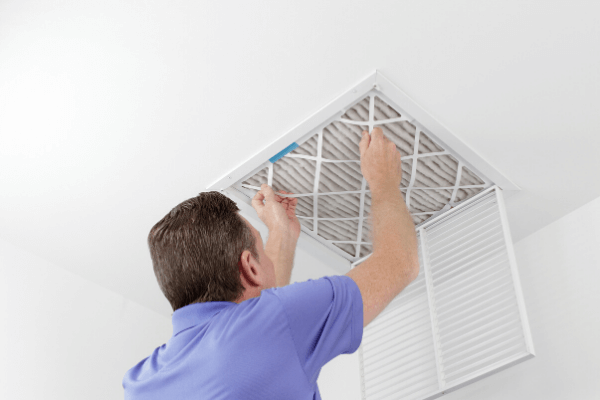 man checking air filter