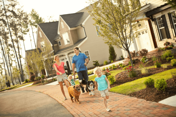 family taking a walk along sidewalk in Briar Chapel