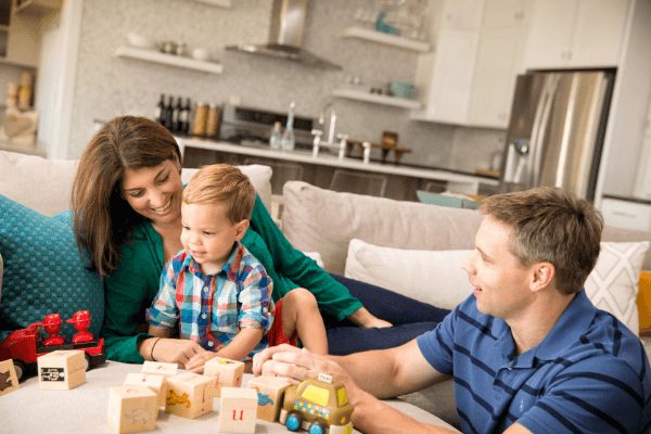 parents and kid playing with blocks