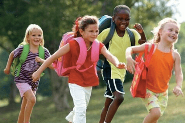 kids with backpacks heading to school