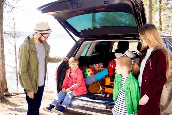 Family packing up car for a road trip