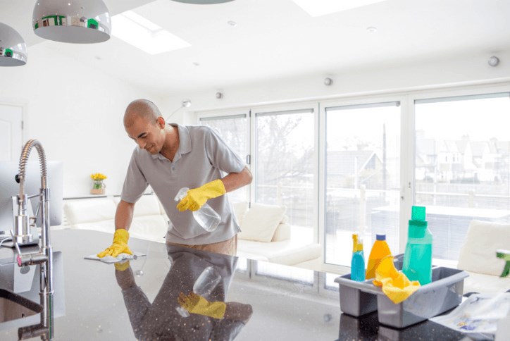 Person cleaning kitchen countertop