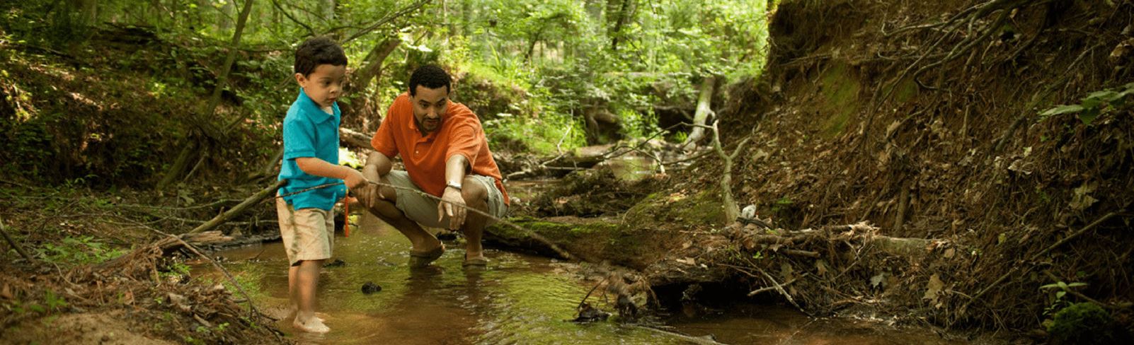 Father and son enjoying pond and stream area near Briar Chapel